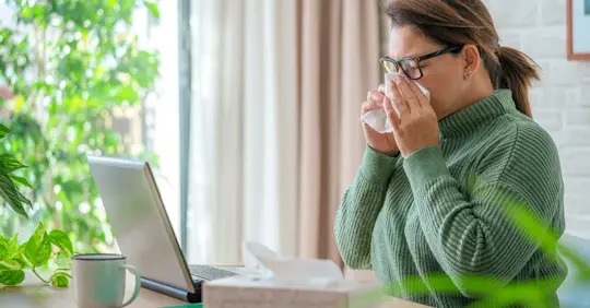A woman sneezing